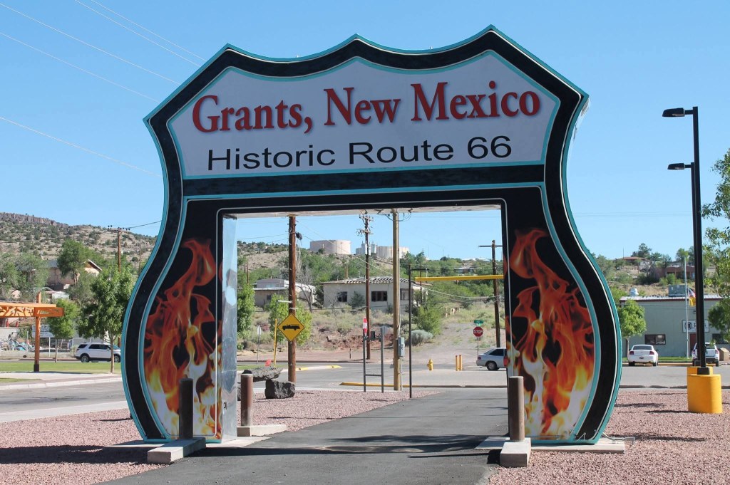 Welcome sign for Grants, New Mexico, featuring a decorative design and the text 'Grants, New Mexico' and 'Historic Route 66' with flames on the sides.
