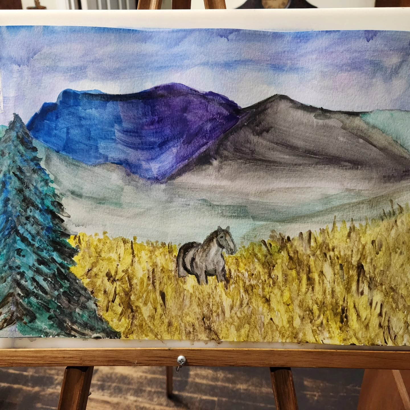 Watercolor painting of a horse in a golden field with mountains by Shawn Marie Graybeal-Sellers