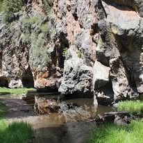 Canyon stream reflecting rock walls in New Mexico